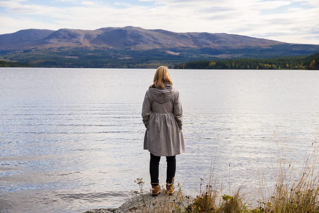 alone thinking woman standing on a stone